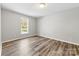 Bedroom showcasing wood-look flooring and a bright window that lets in natural light at 116 Ridgewood Dr, York, SC 29745