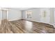 Bright living room featuring wood-look flooring, a large window, and a white front door at 116 Ridgewood Dr, York, SC 29745
