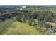 Beautiful aerial view of a home nestled amongst trees with lake view at 116 Whispering Cove Ct, Mooresville, NC 28117