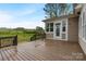 Home exterior features a large wooden deck overlooking a green backyard at 116 Whispering Cove Ct, Mooresville, NC 28117