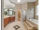 The primary bathroom has a tub, tiled floor, double vanity, and separate walk-in closet at 116 Whispering Cove Ct, Mooresville, NC 28117