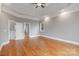 Spacious bedroom with hardwood flooring, recessed lighting, a tray ceiling, and neutral paint at 116 Whispering Cove Ct, Mooresville, NC 28117