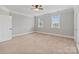 Bedroom with neutral walls, carpet, and a large window bringing in light at 116 Whispering Cove Ct, Mooresville, NC 28117