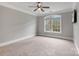 Spacious bedroom with a large window letting in ample natural light and a ceiling fan at 116 Whispering Cove Ct, Mooresville, NC 28117