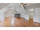 Spacious bonus room with hardwood floors, wainscoting, and a stone accent bar at 116 Whispering Cove Ct, Mooresville, NC 28117