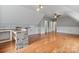 Bright bonus room featuring a stone accent bar, hardwood floors and recessed lighting at 116 Whispering Cove Ct, Mooresville, NC 28117