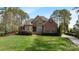 Charming two-story home features a stone and brick exterior with manicured landscaping and mature trees at 116 Whispering Cove Ct, Mooresville, NC 28117