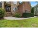 Charming home with stone accents, a welcoming front entrance, and lush green lawn at 116 Whispering Cove Ct, Mooresville, NC 28117