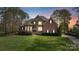 Charming two-story brick and stone home with lush landscaping and a well-manicured lawn at 116 Whispering Cove Ct, Mooresville, NC 28117