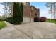 Spacious three-car garage with an expansive driveway and well-maintained landscaping at 116 Whispering Cove Ct, Mooresville, NC 28117