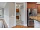 Hallway view leading to kitchen with stainless steel fridge at 116 Whispering Cove Ct, Mooresville, NC 28117