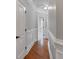 Hallway with hardwood floors, paneled walls, and multiple doorways at 116 Whispering Cove Ct, Mooresville, NC 28117