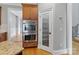 Kitchen view with stainless double oven, pantry door, wood cabinets and flooring at 116 Whispering Cove Ct, Mooresville, NC 28117