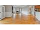 Open-concept living room with fireplace, crown molding and hardwood floors at 116 Whispering Cove Ct, Mooresville, NC 28117