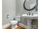 Elegant powder room featuring a pedestal sink and classic fixtures at 116 Whispering Cove Ct, Mooresville, NC 28117