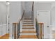 The staircase is finished with hardwood steps, wood railings, and black iron balusters at 116 Whispering Cove Ct, Mooresville, NC 28117