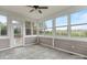 The sunroom has neutral tiling and multiple windows allowing natural light to flood the room at 116 Whispering Cove Ct, Mooresville, NC 28117