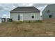 Rear exterior of a grey home with a sliding glass door and small window surrounded by lawn at 120 Parson Ln, Statesville, NC 28625
