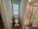 Bathroom featuring a toilet, window, walk-in shower and tiled floor at 120 Parson Ln, Statesville, NC 28625