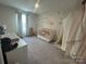 Bedroom with carpeted floor, decorative wall, and crib at 120 Parson Ln, Statesville, NC 28625