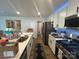 Modern kitchen featuring stainless steel appliances, quartz countertops, and ample cabinet space at 120 Parson Ln, Statesville, NC 28625