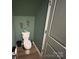Powder room with toilet, laminate floor, and green paint at 120 Parson Ln, Statesville, NC 28625