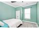 Light-filled bedroom featuring a ceiling fan, double door closet, and a large window for natural light at 1224 Horsesugar Rd, Clover, SC 29710