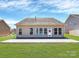The back of the house features a patio, a door and many windows at 1224 Horsesugar Rd, Clover, SC 29710