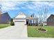 Charming single-Gathering home with a manicured lawn, blue shutters, and an attached two-car garage at 1224 Horsesugar Rd, Clover, SC 29710