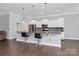 Modern kitchen with stainless steel appliances, granite countertops, and bar seating, seamlessly connected to the living space at 1224 Horsesugar Rd, Clover, SC 29710