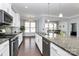 Well-equipped kitchen with granite countertops, stainless steel appliances, and a view into the dining area with natural light at 1224 Horsesugar Rd, Clover, SC 29710