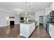 Expansive kitchen with granite island, white cabinets, stainless steel appliances, flowing into a living area with fireplace feature at 1224 Horsesugar Rd, Clover, SC 29710