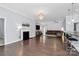 Spacious living area with a fireplace, hardwood floors, and seamless transition to the kitchen with bar seating at 1224 Horsesugar Rd, Clover, SC 29710