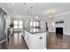Spacious kitchen with granite island, stainless appliances, and a seamless transition to the living room with a cozy fireplace at 1224 Horsesugar Rd, Clover, SC 29710