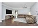 Cozy living room with hardwood floors, a large sectional sofa, a big screen TV and neutral decor at 1224 Horsesugar Rd, Clover, SC 29710