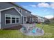 Spacious backyard with a patio featuring a fire pit and outdoor seating at 136 Morgans Branch Rd, Belmont, NC 28012