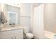 Bathroom featuring single vanity, toilet, and bathtub-shower combo with patterned curtain at 136 Morgans Branch Rd, Belmont, NC 28012