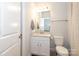 Clean bathroom with white vanity, granite counter, and well-lit mirror, combining functionality and style at 136 Morgans Branch Rd, Belmont, NC 28012