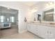 Bright bathroom featuring double vanity, granite countertops and large mirror over looking bedroom at 136 Morgans Branch Rd, Belmont, NC 28012