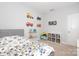 Playful bedroom featuring decorative wall trucks, shelves and a cozy book nook at 136 Morgans Branch Rd, Belmont, NC 28012