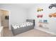 Neutral-toned bedroom with toddler bed featuring a closet, shelving, and -themed decorations at 136 Morgans Branch Rd, Belmont, NC 28012