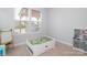 Bright bedroom with neutral walls and carpet, featuring multiple windows and play area at 136 Morgans Branch Rd, Belmont, NC 28012