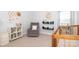 Charming Bedroom with a crib, gray chair, white shelving, and colorful decor, ideal for a baby's room at 136 Morgans Branch Rd, Belmont, NC 28012