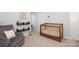 Cozy Bedroom featuring a wooden crib, comfortable chair, and playful decor, perfect for baby at 136 Morgans Branch Rd, Belmont, NC 28012