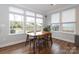 Dining room features neutral walls, wood floors, 4 chairs, and three large windows at 136 Morgans Branch Rd, Belmont, NC 28012