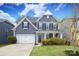 Charming two-story home features a well-manicured lawn and a classic architectural design at 136 Morgans Branch Rd, Belmont, NC 28012