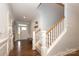 Bright foyer featuring hardwood floors, staircase with white spindles, and a bench by the front door at 136 Morgans Branch Rd, Belmont, NC 28012