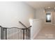 Upstairs hallway with carpet flooring and baby gate, showcasing the home's interior design at 136 Morgans Branch Rd, Belmont, NC 28012