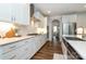 Bright kitchen with white cabinets, granite countertops, stainless steel appliances, and wood flooring at 136 Morgans Branch Rd, Belmont, NC 28012