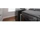 The laundry room featuring a dark washer and dryer set and hardwood floors at 136 Morgans Branch Rd, Belmont, NC 28012